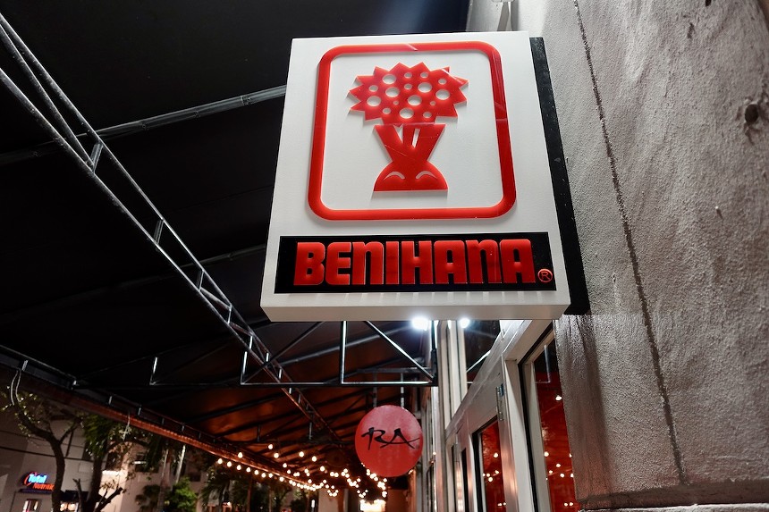 A red and white sign outside of a restaurant